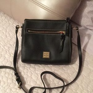 Small Dooney crossbody bag, measures approx. 8.5 x 8. Zip top closure.
